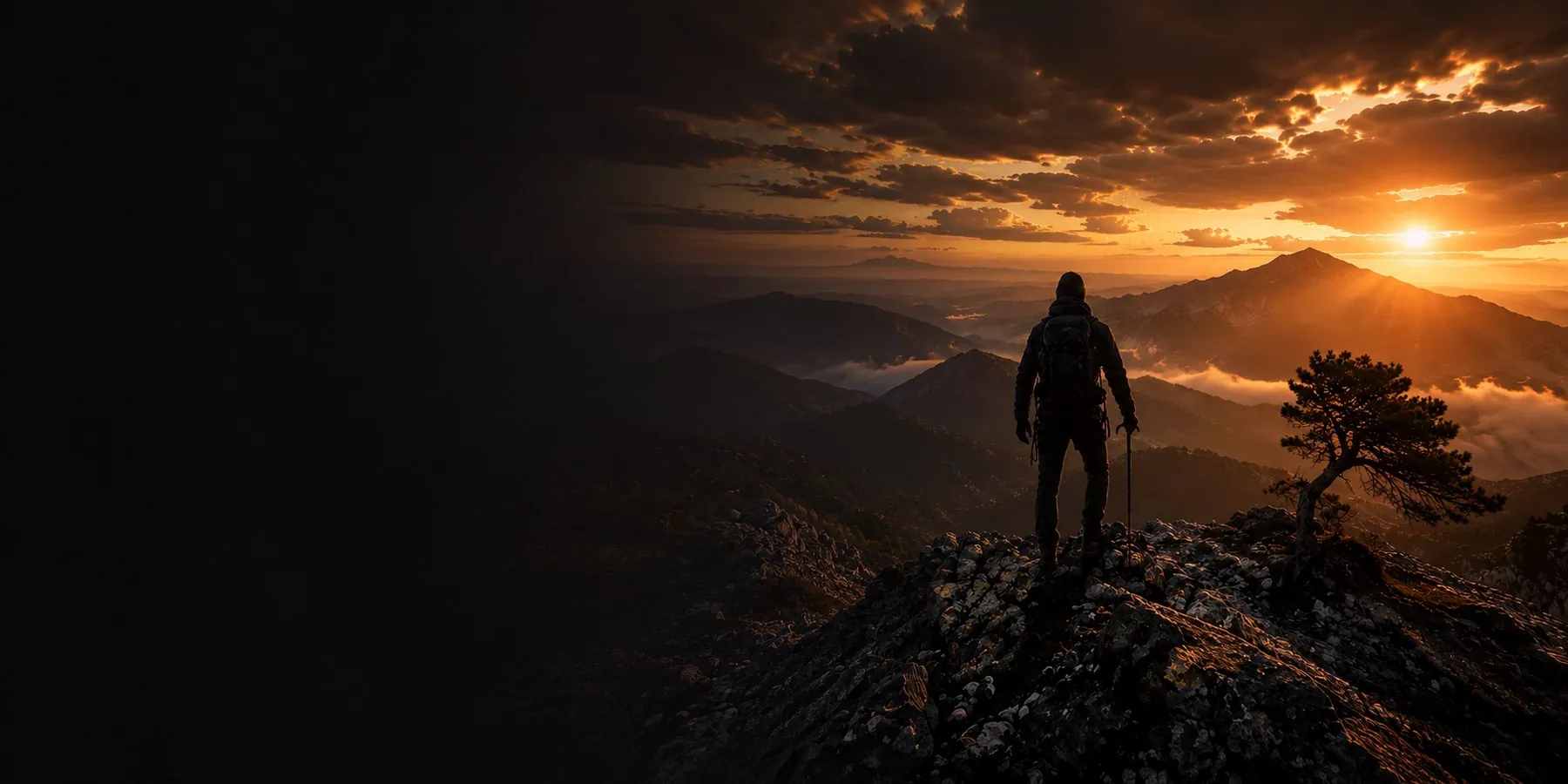 A walker on a mountain ridge at sunrise